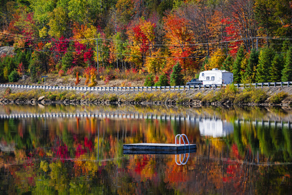 RV Traveling In Colored Road In Fall